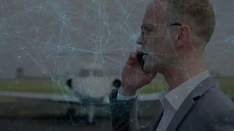 Man holding phone under web overlay, making business call while camera pulling 스톡 동영상 332505129
