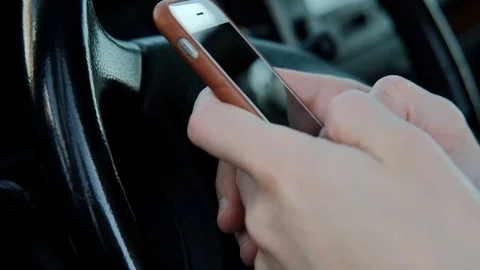 Man holding phone work looking for information in car cabin Stock Footage 74317694