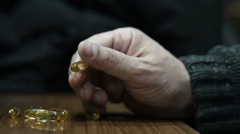 Man holding a pill and finally takes it Stock Footage 58950853