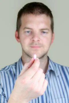 Man holding a pill Stock Photos