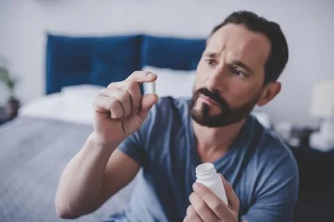 Man holding pill Stock Photos