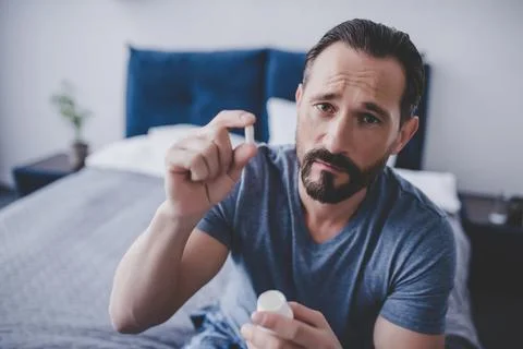 Man holding pill Stock Photos