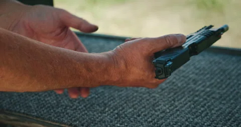Man holding pistol preparing to shoot during training session at shooting range Stock Footage 311489169