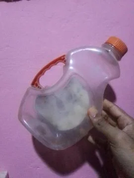 Man Holding Plastic Bottle 스톡 사진