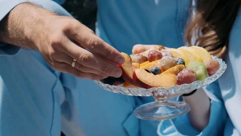 Man holding a plate of fruit Stock Footage 252527865
