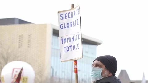 Man is holding a poster which show that he is against proposed new law Stock Footage 154693714