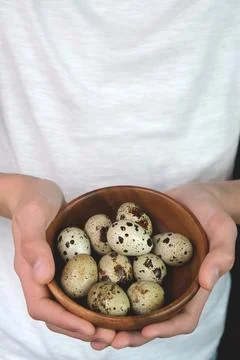 The man is holding quail eggs. Preparing for the Easter holiday. Stock Photos