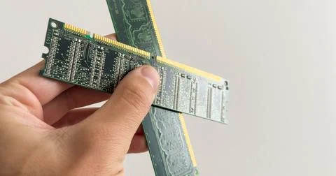 Man holding up a RAM module, or random access memory, in which all storage Stock Photos