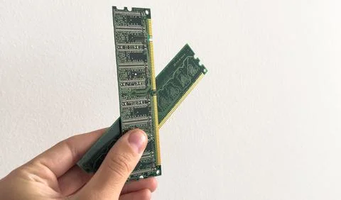Man holding up a RAM module, or random access memory, in which all storage Stock Photos