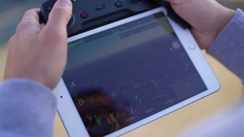 Man holding remote control with tablet and controlling drone, close-up Stock Footage 133260418