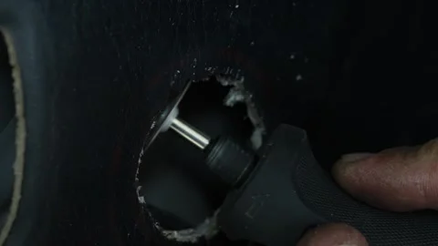 Man holding a rotary tool with a cutting disc blade. Vídeo Stock 344365004