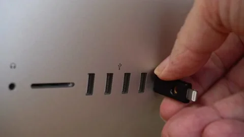 Man holding security key for authentication purpose and insert into Computer Stock Footage 137839127