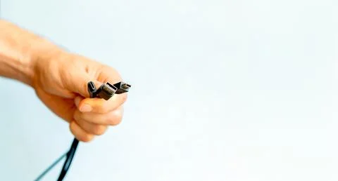  man holding several cables in hand, different types of USB cables Stock Photos