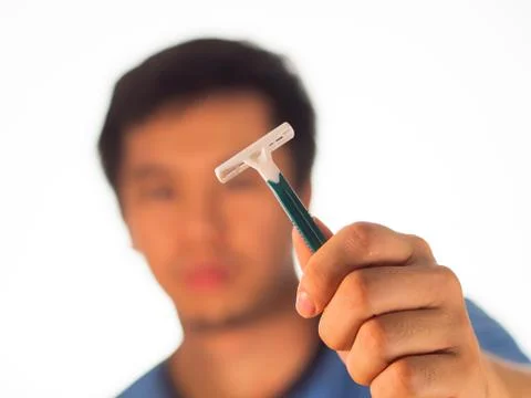 Man holding a sharp shaving razor 写真素材