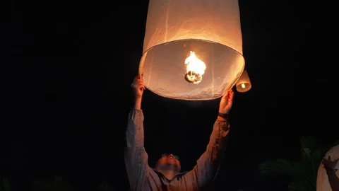 Man Holding Sky Lantern During Yi Peng Festival Stock Footage 327706170