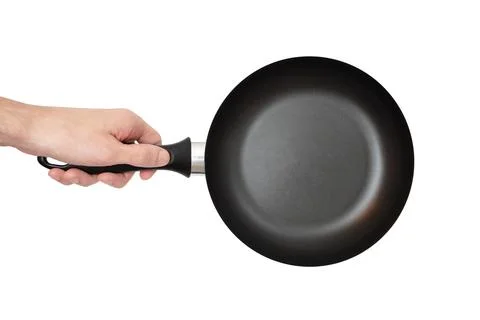 Man is holding an small empty black frying pan. Isolated on a white background Stock Photos