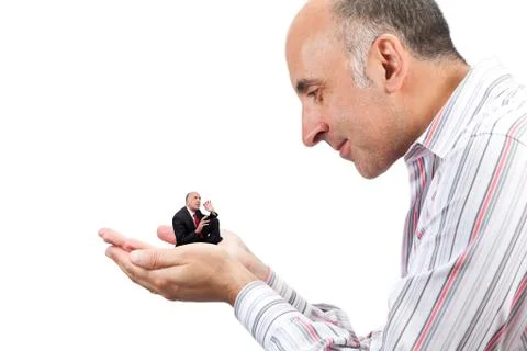Man holding a small version of himself in his hand Foto stock