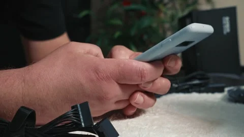 Man holding smartphone and checking information during PC build Video stock 325805439