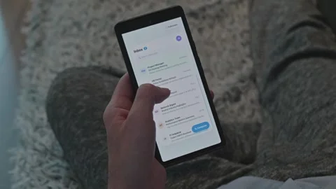Man holding smartphone and checking email inbox while relaxing at home, remote Vidéo 341569157