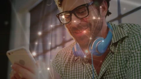 Man holding smartphone and tapping thumb, smiling and causing network nodes Stock Footage 332772153