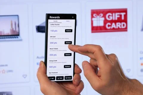 Man Holding Smartphone And Using Loyalty App To Earn Reward Points. Stock Photos