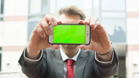 A man holding a smartphone to the camera Stock Footage 104321357