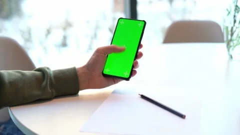 Man Holding Smartphone with Chroma Key Screen swiping screens web site green Stock Footage 171815497