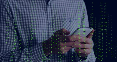 Man holding smartphone in dim studio, overlaying green binary code suggesting Stock Footage 309285316