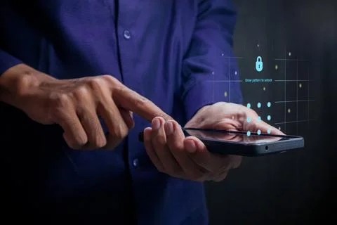 Man holding a smartphone to draw pattern to unlock screen 写真素材