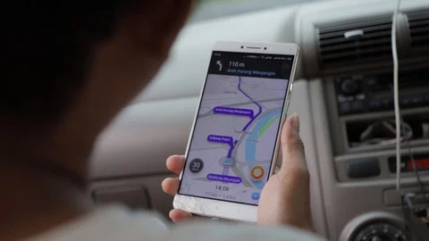 A Man Holding Smartphone with GPS Navigation Apps Open, Surabaya, East Java Stock Footage 129367544