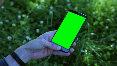 Man holding a smartphone with green screen. Stock Footage 92007993