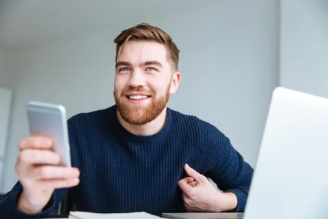 Man holding smartphone at home Stock Photos