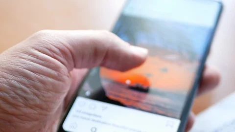 Man holding smartphone with opened application famous social network Stock Footage 116058423