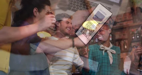 Man holding a smartphone with qr code on screen against group of friends Stock Footage 161013137