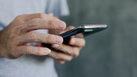 Man holding smartphone Type text and touch screen Stock Footage 163906335