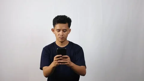 Man holding smartphone typing message isolated white background Stock Footage 314935670