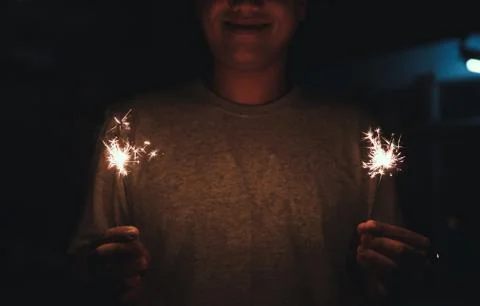 A man holding sparklers firework Stock Photos