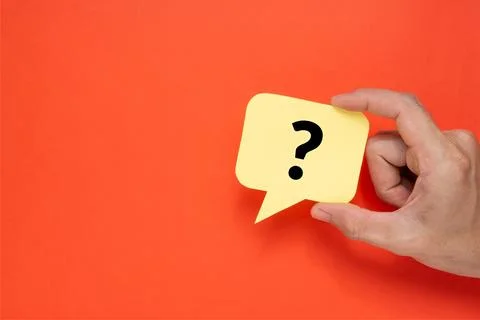 A man holding speech bubble with a question mark. Creative concept on red backgr Stock Photos