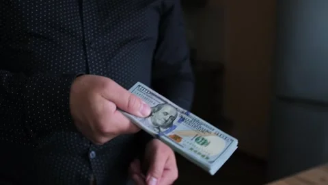 Man holding stack of 100 dollars in hands close up. Stock Footage 243986163