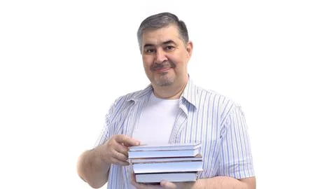 Man Holding Stack of Books and Smiling at the Camera Stock Photos