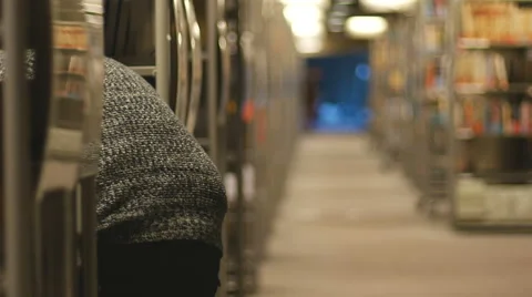 Man holding a stack of books in library Video stock 47007047