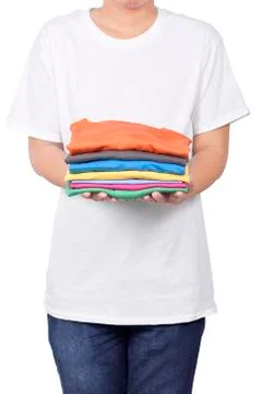 Man holding stack of folded clothes in his hand Stock Photos