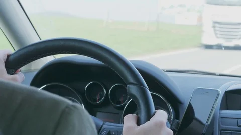 Man holding steering wheel during car driving on rush road Stock Footage 106015014
