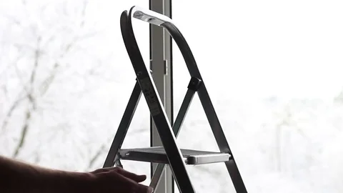 Man holding a step-ladder Stock Footage 70750212