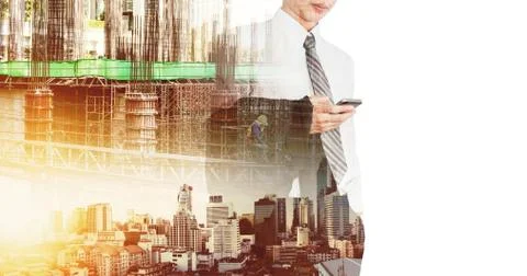 A man holding suit and using smartphone with double exposure construction site Foto stock