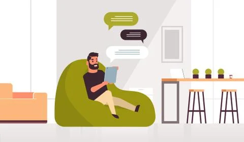 Man holding tablet chatting messaging guy sitting at bean bag using mobile ap 스톡 일러스트
