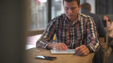 Man holding tablet computer with graphic in cafe Stock Footage 68972911