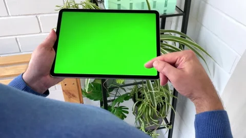Man Holding Tablet Computer with Green Screen Mock Up Display. Stock Footage 255771446