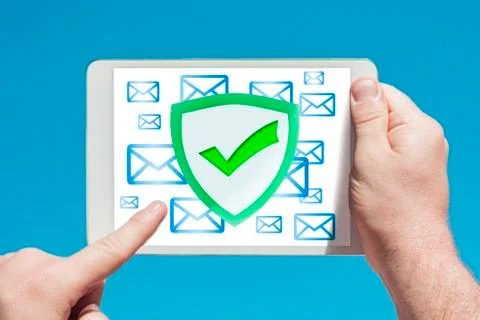 Man holding a tablet device pointing at an anti-spam, security firewall icon Stock Photos
