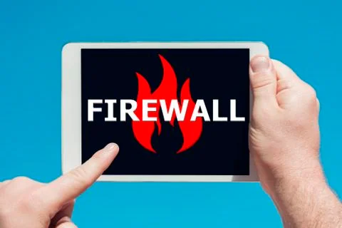 Man holding a tablet device pointing at an anti-spam, security firewall icon Stock Photos